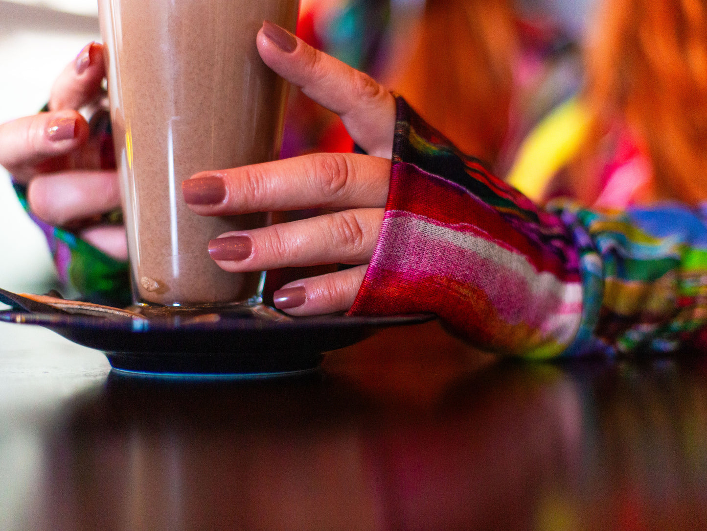 Location shoot with VF model Jasmine, close up detail shot of her holding a hot chocolate, features the arm warmer cuffs