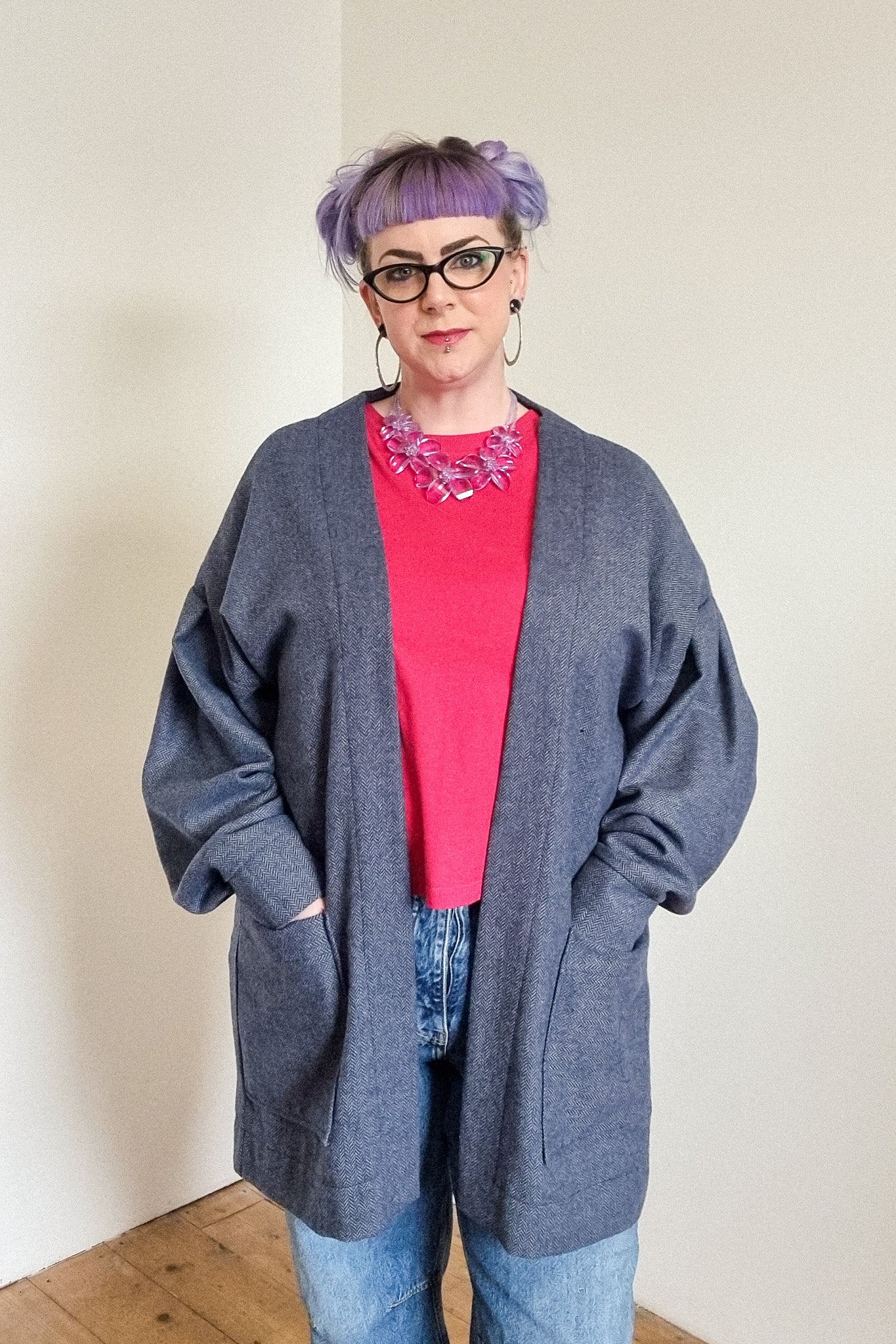 Lindsey the company owner wears the blue herringbone wool cardigan, with large patch pockets, front view