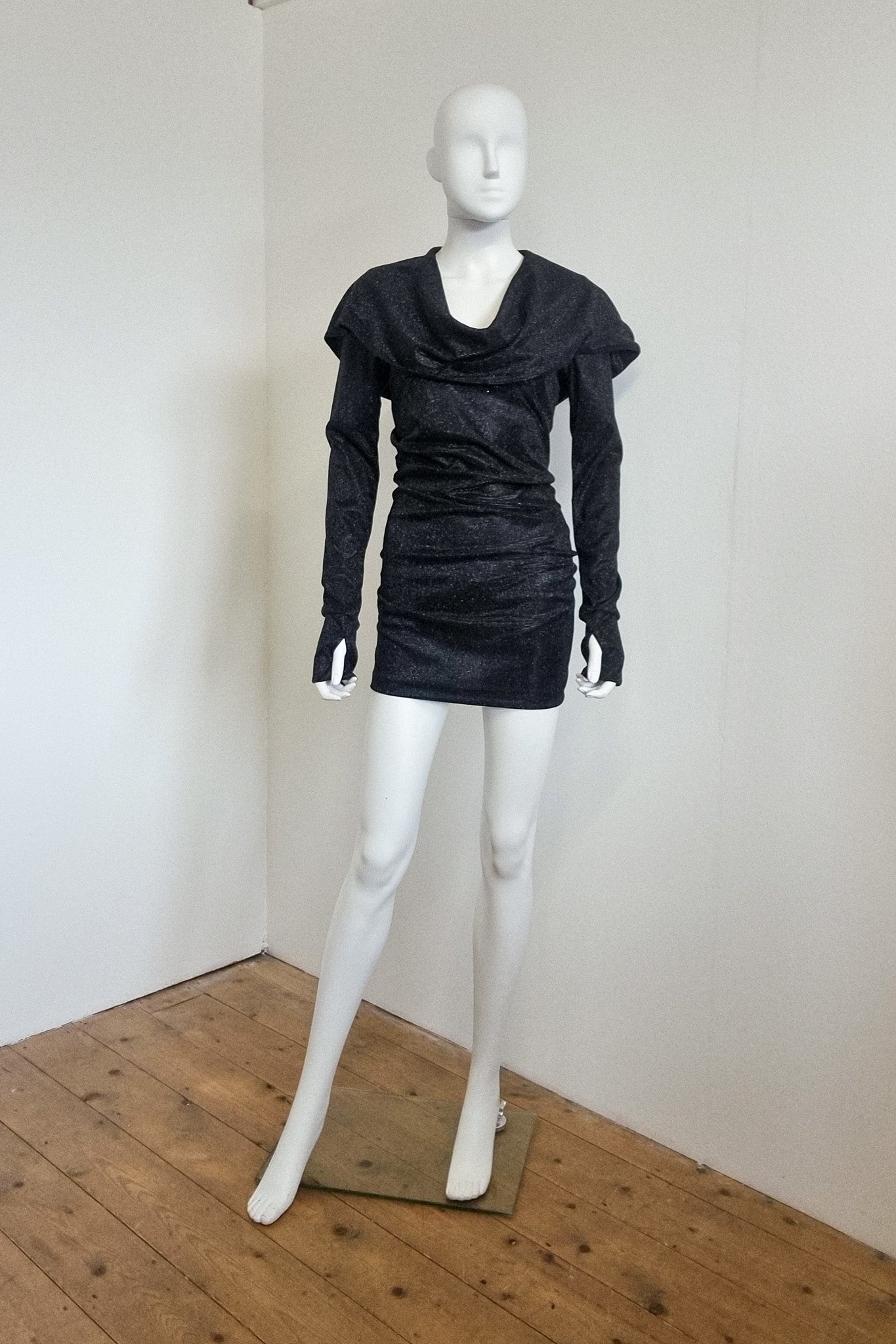 Mannequin wears the black glitter Grace mini with the hood down, front view