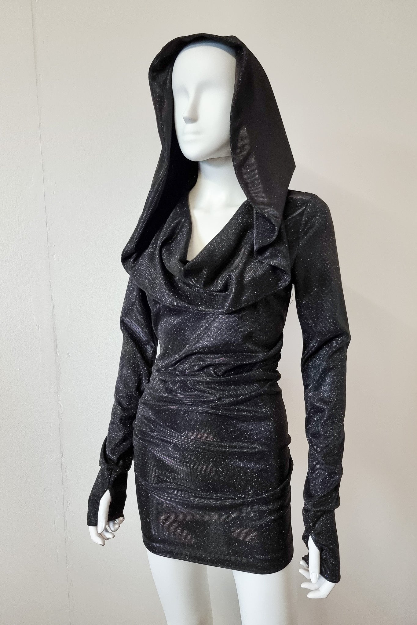Detailed shot of the dress up close, mannequin wears the Grace dress with the hood up