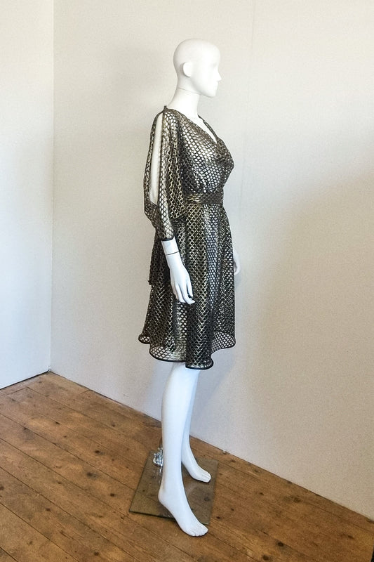 Leeloo the studio mannequin wears the Bea dress in bronze gold mesh. Side view belted.