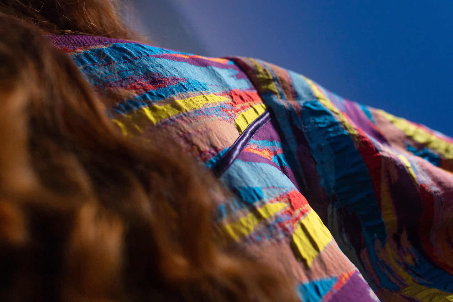 Model Amy wears the Kitty coat, detailed shot of the binding detail on the back yolk of the jacket