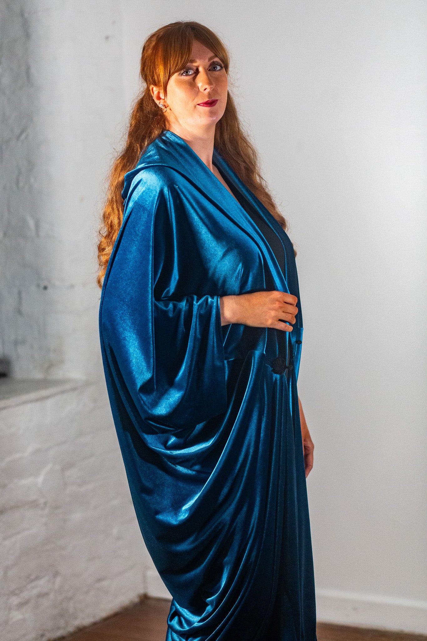 Model Amy wears the long teal Ophelia, detail of the side drape