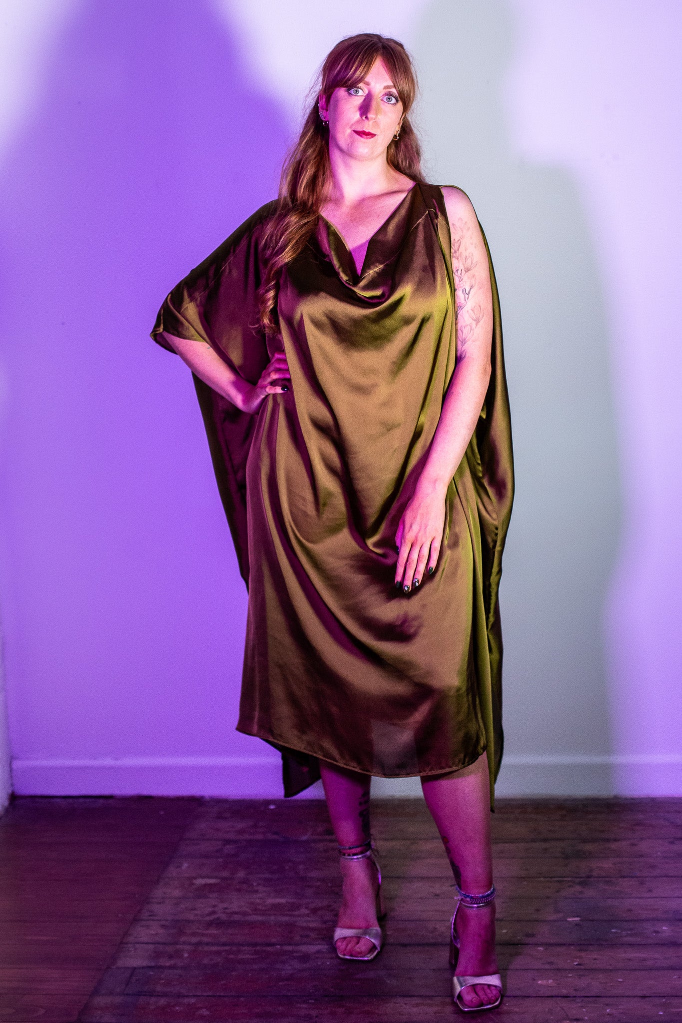 Our model Amy wears the Bea unbelted and shot in a purple light.