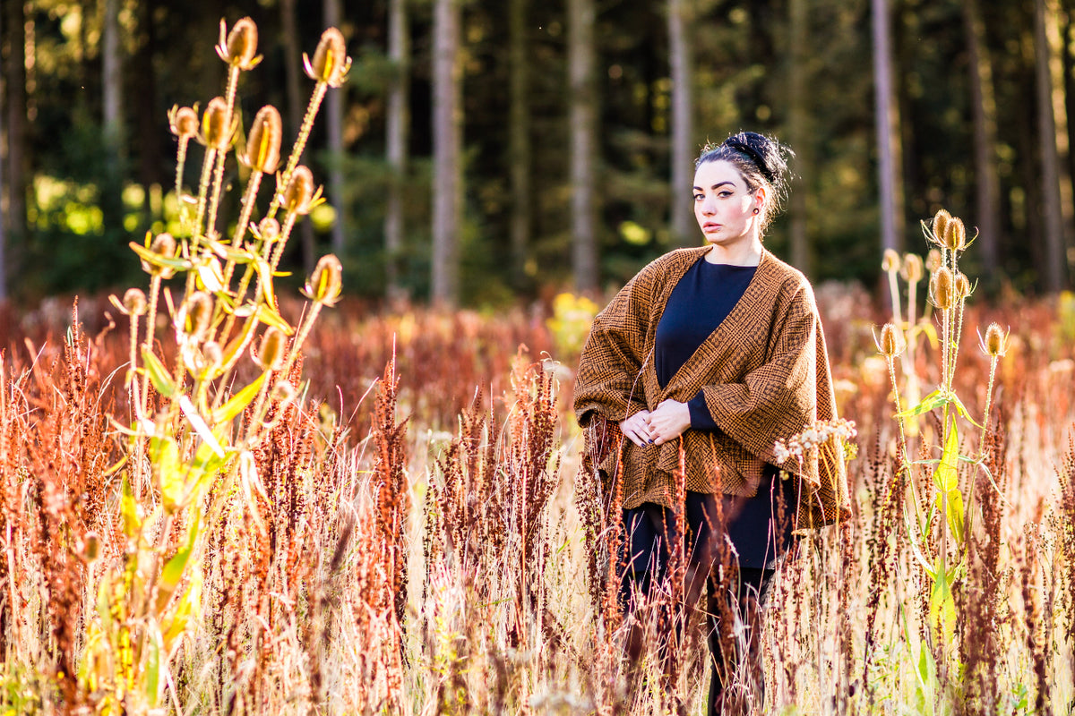 Lou wearing the Lola cape in mustard and black British wool