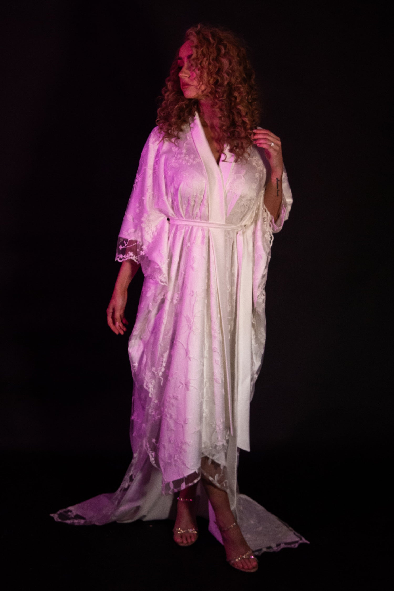 Cindy wears the Bellatrix gown lit by a purple light