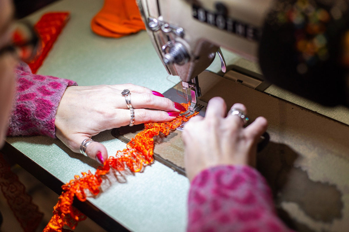 Detailed shot of Lindsey working on the industrial sewing machine