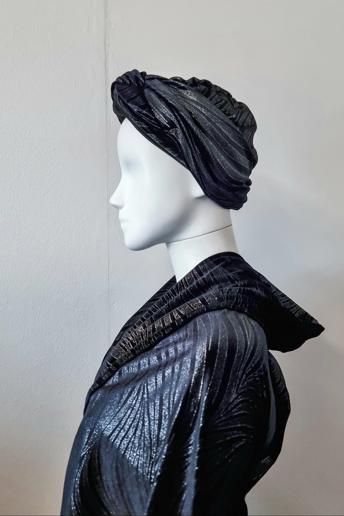 Riri worn in a smoother traditional turban style, side view