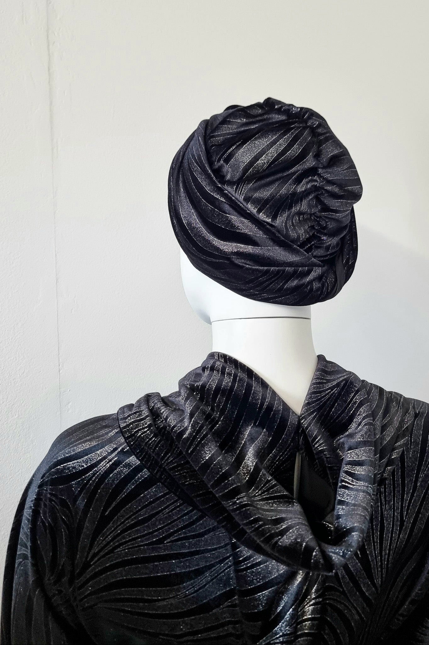 Riri worn in a smoother traditional turban style, back view